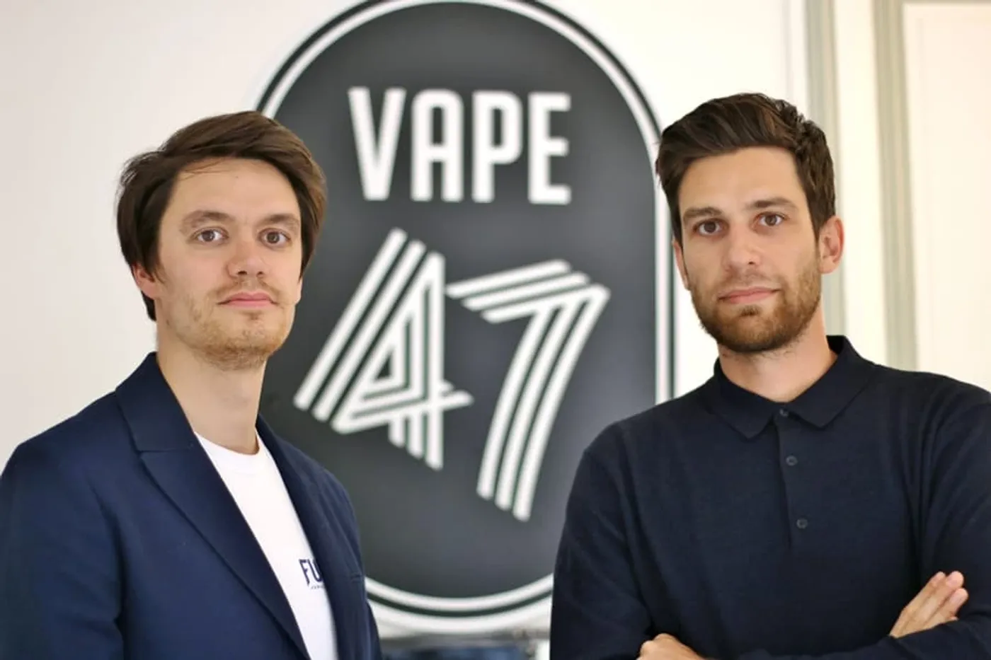 Les cofondateurs de VAPE 47 devant le logotype de l'entreprise